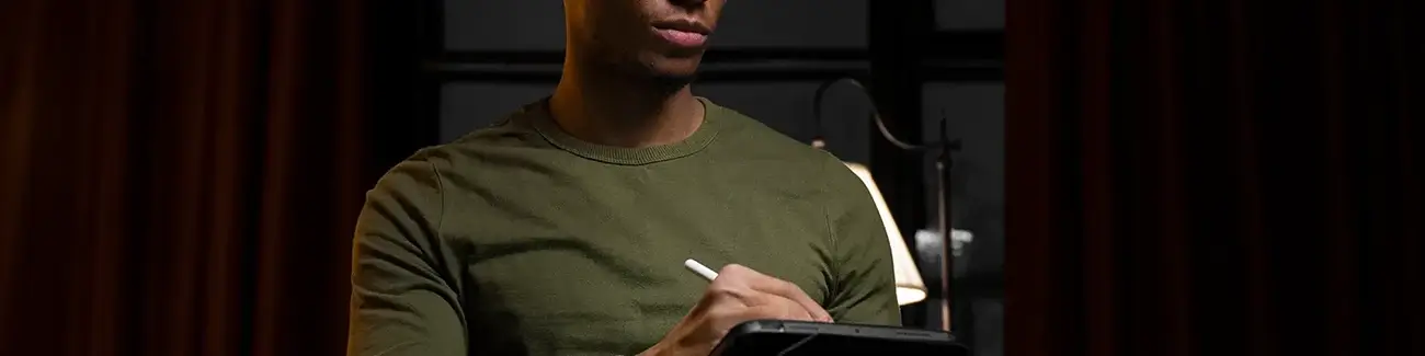 Man standing up while using tablet