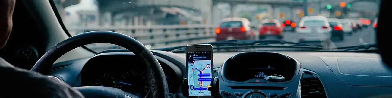 Person in a traffic jam with their mobile phone on the dashboard